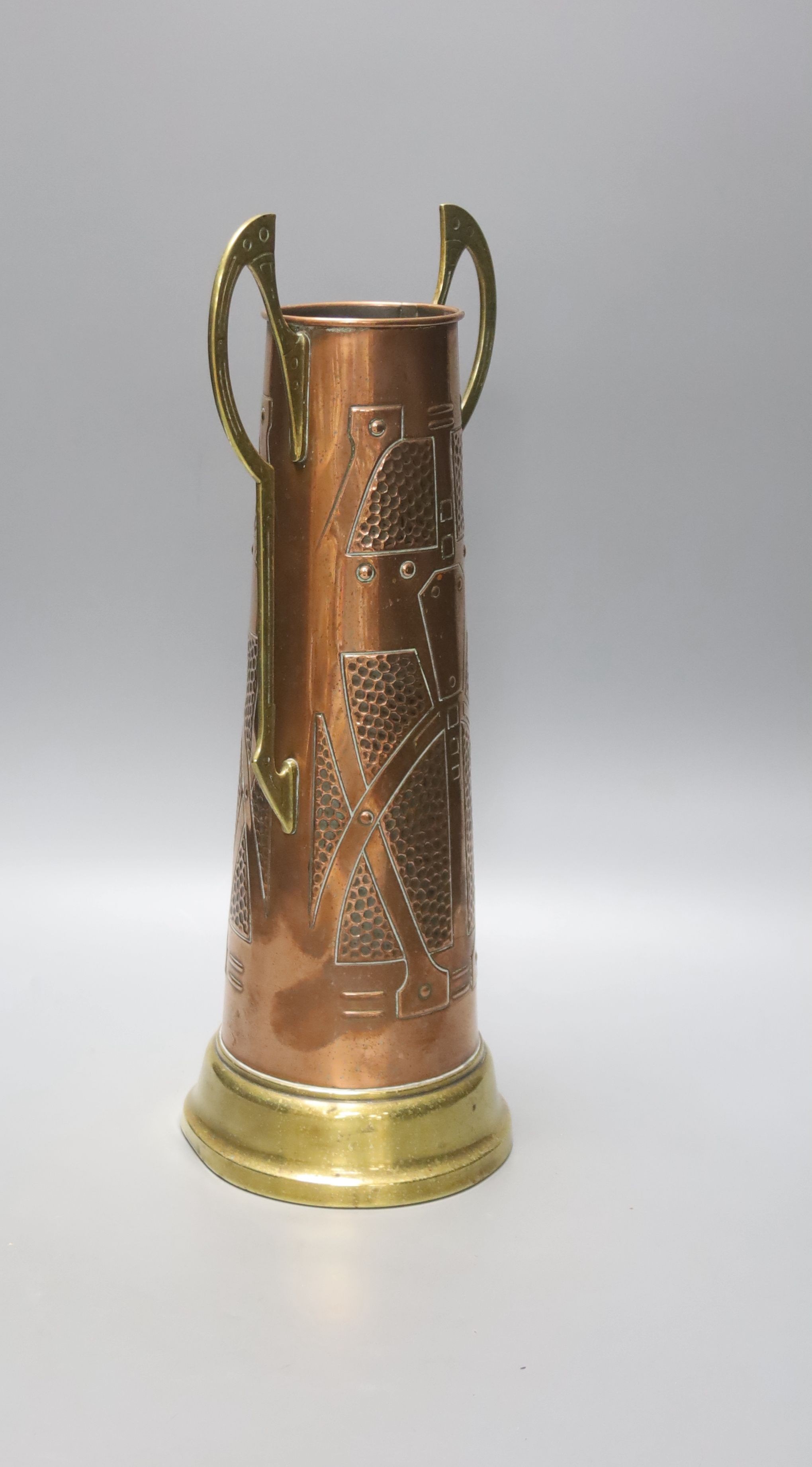 A Secessionist style copper and brass two handled cup, 40cm